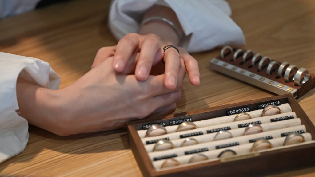A bespoke wedding band consultation with ring samples and custom design discussions at a jewellery workshop