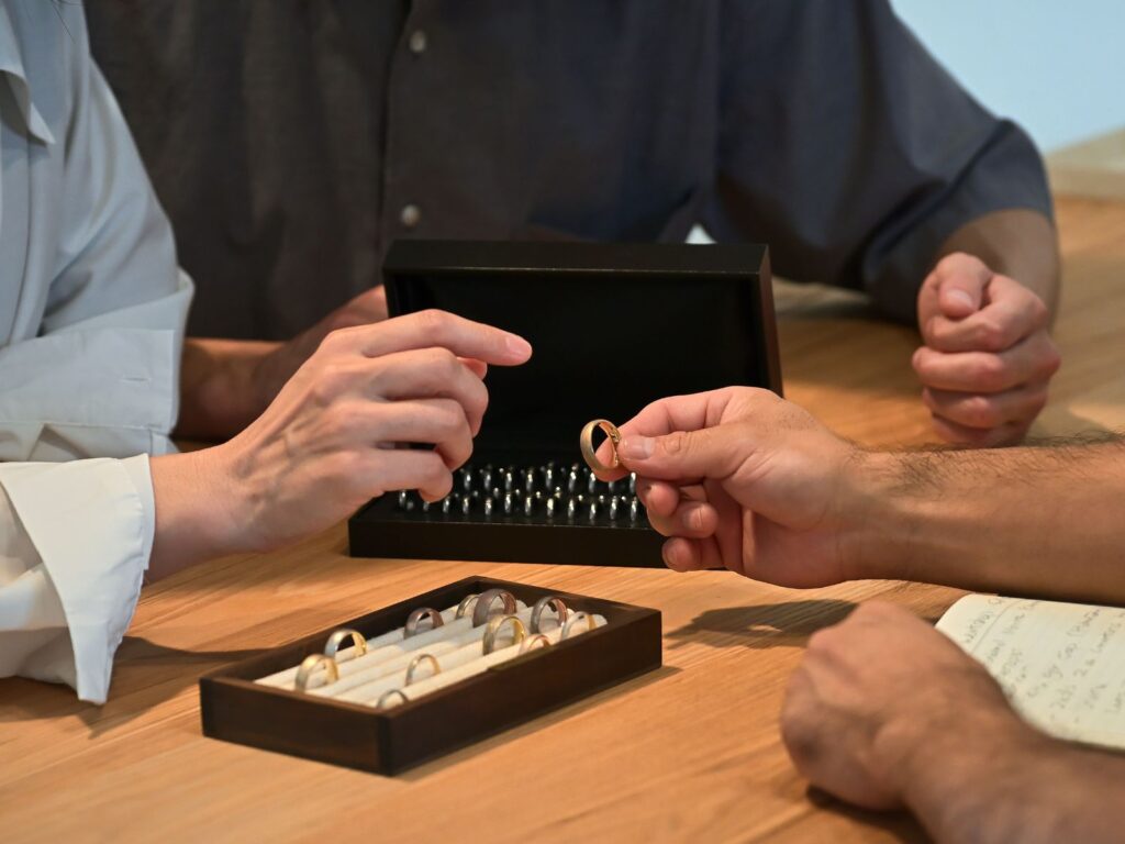 Bespoke jewellery consultation, discussing design ideas while examining sample rings