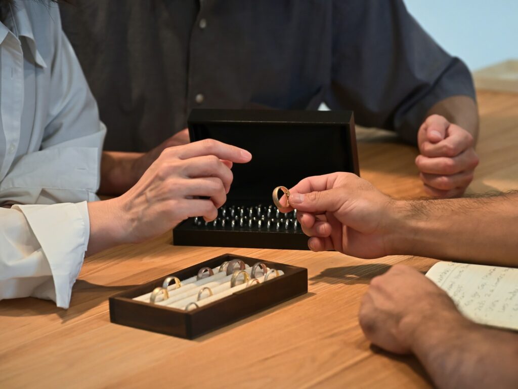 A bespoke wedding band consultation with customers reviewing ring samples and discussing custom designs