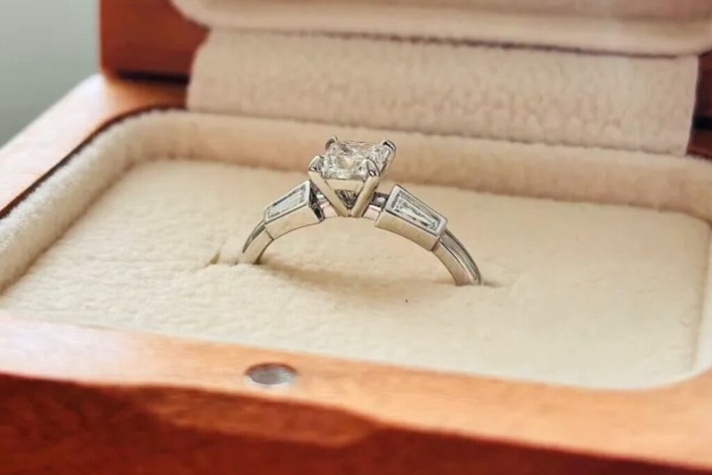 Custom-made solitaire engagement ring with a princess-cut diamond and tapered baguette diamond accents