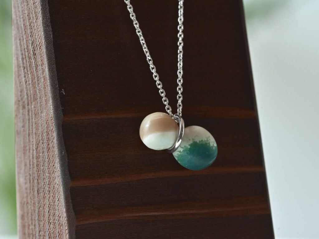 Memory of the Okinawan Sea pendant carved from green turbo shell in a gourd-like shape