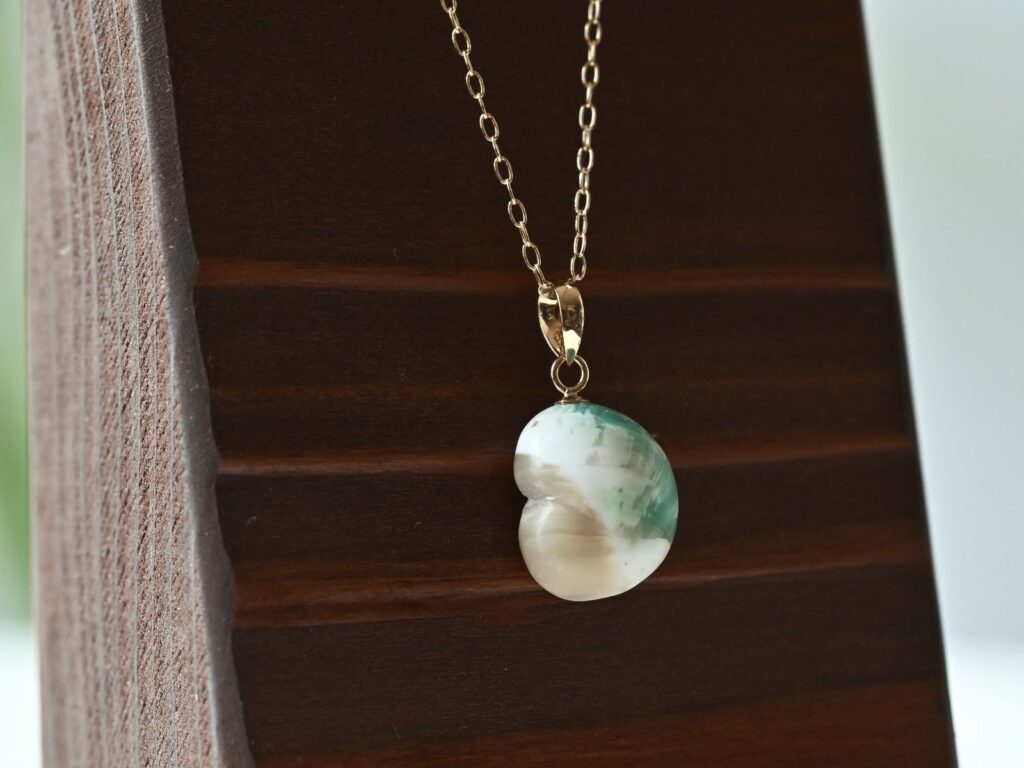 Green turbo shell pendant with a smooth rounded shape from the Memory of the Okinawan Sea collection