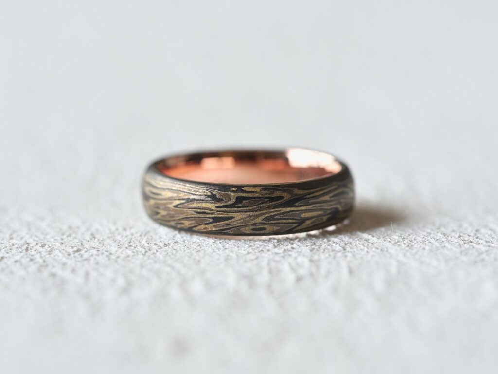 Ancient Mokumegane ring featuring an oxidised woodgrain pattern and rose gold liner