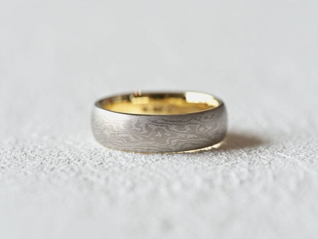 Classic Two Tone Mokumegane ring featuring subtle woodgrain patterns and a gold liner