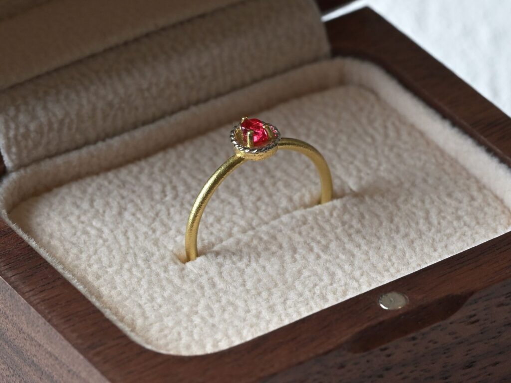 Primitive ring featuring a rough ruby set in 18K green gold and platinum