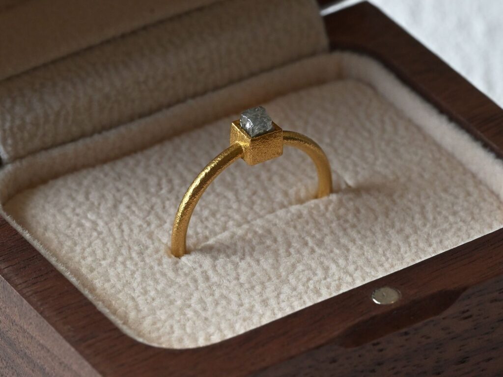 Primitive ring featuring a grey rough diamond set in 18K yellow gold