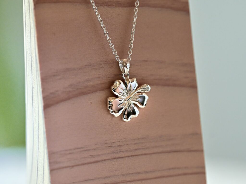 Silver necklace featuring a hibiscus pendant