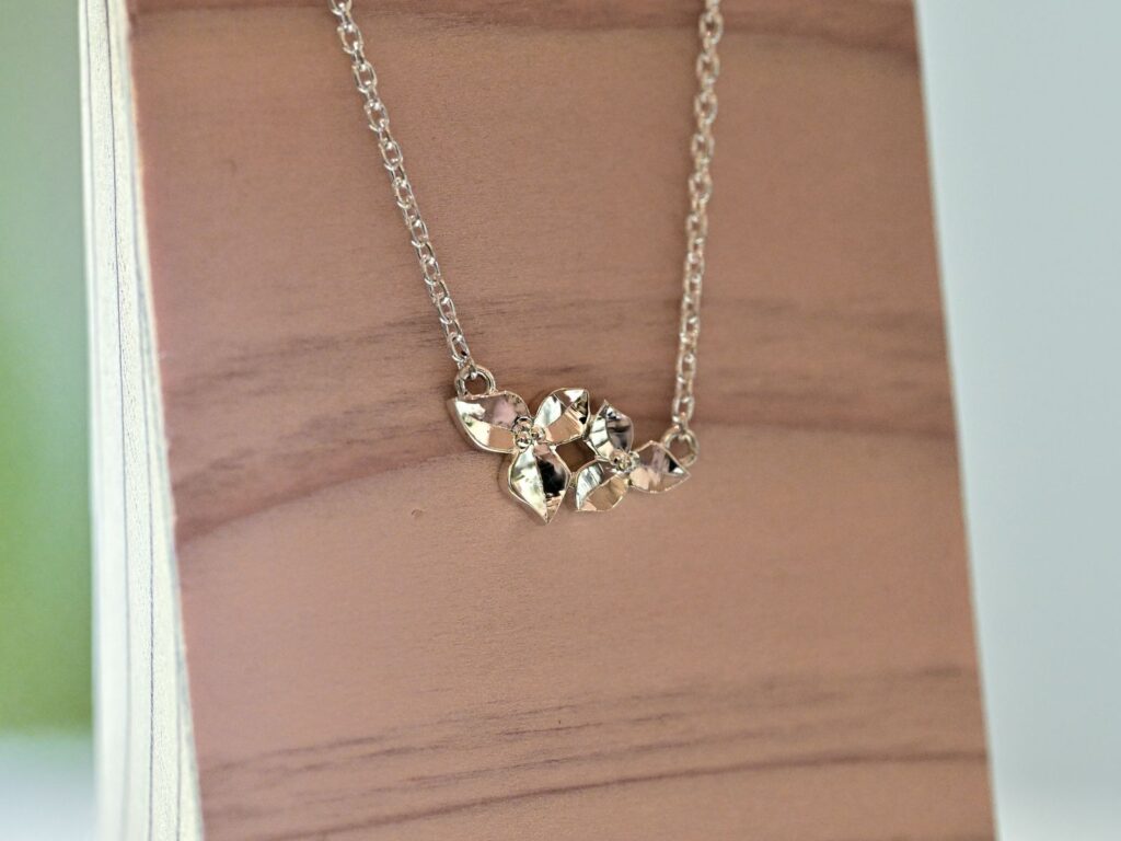 Silver necklace featuring a bougainvillea pendant