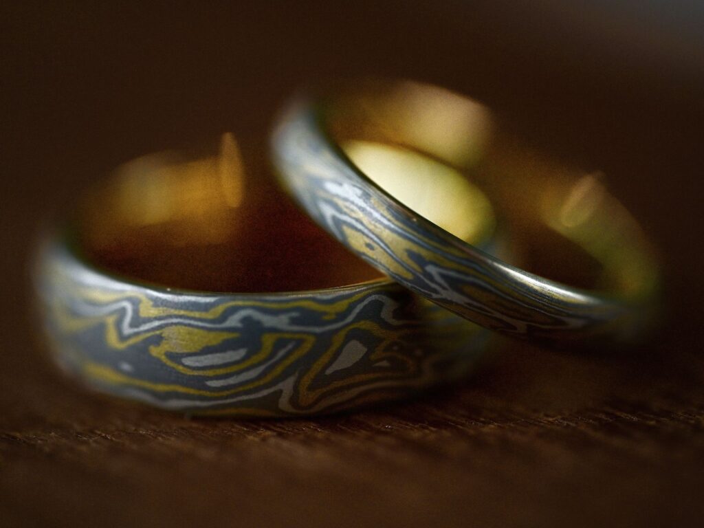 Mokumegane wedding bands featuring unique woodgrain patterns created from layered metals