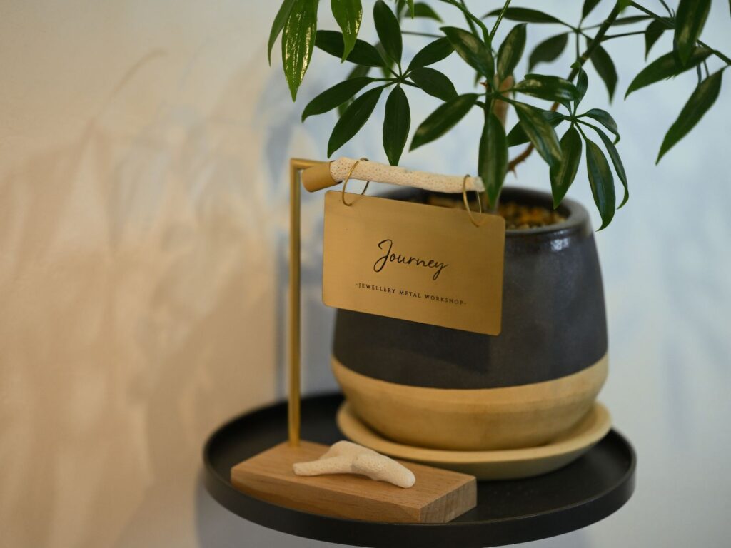 Interior detail of Journey jewellery workshop in Okinawa, featuring the studio sign and greenery