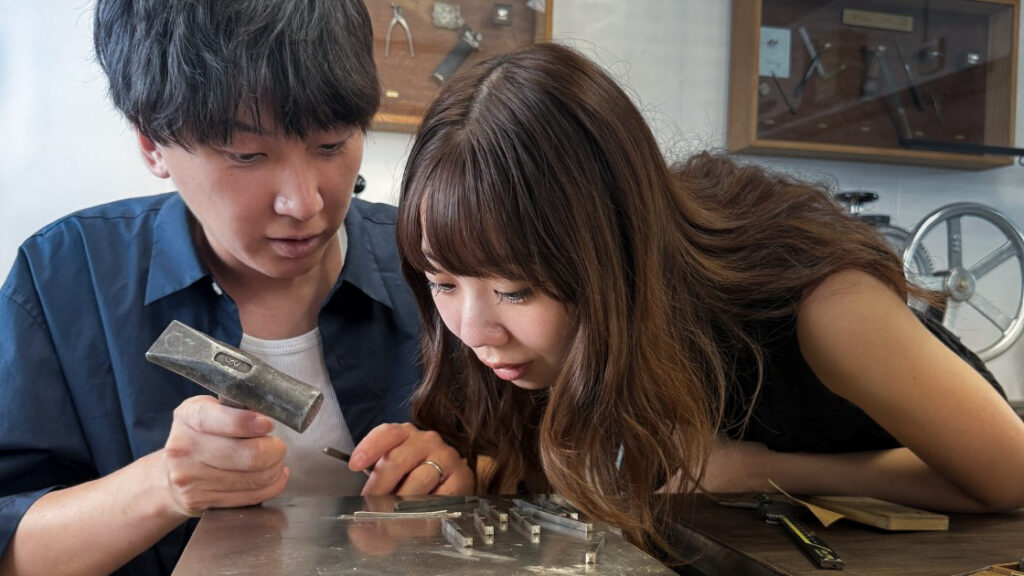 A couple creating personalised wedding bands during a wedding band workshop in Okinawa